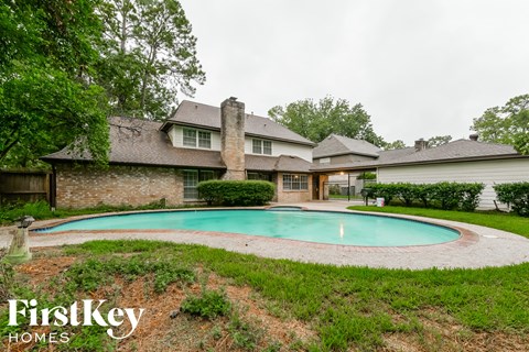 A house with a pool in the backyard.