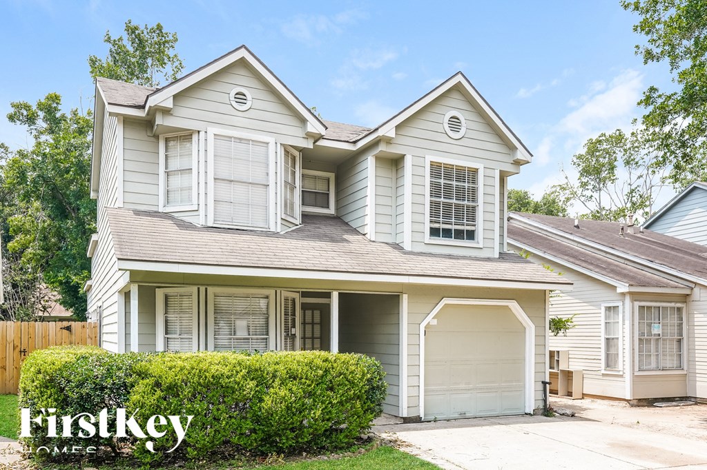 a white house with white shutters and a garage