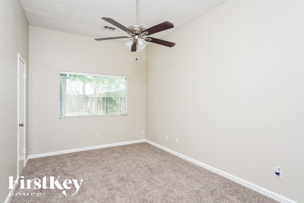 a bedroom with carpet and a ceiling fan