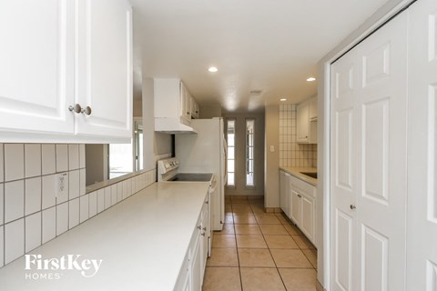 a large white kitchen with white cabinets and white counter tops