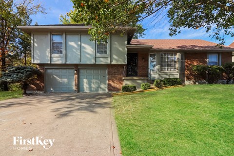 a house with two garage doors and a lawn