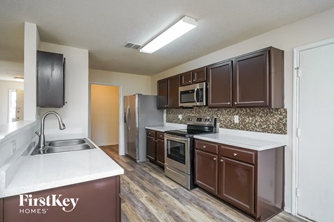 a kitchen with wooden cabinets and stainless steel appliances