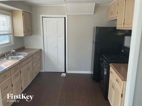a small kitchen with a sink and a refrigerator