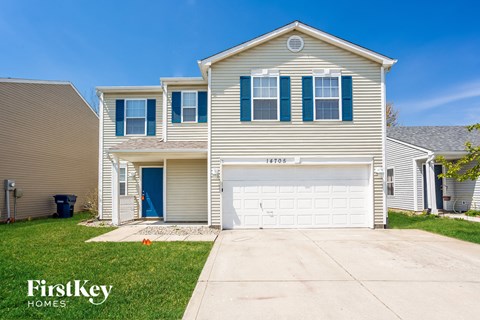 a beige house with a white garage door