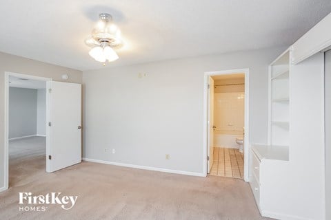 a bedroom with a closet and a ceiling fan