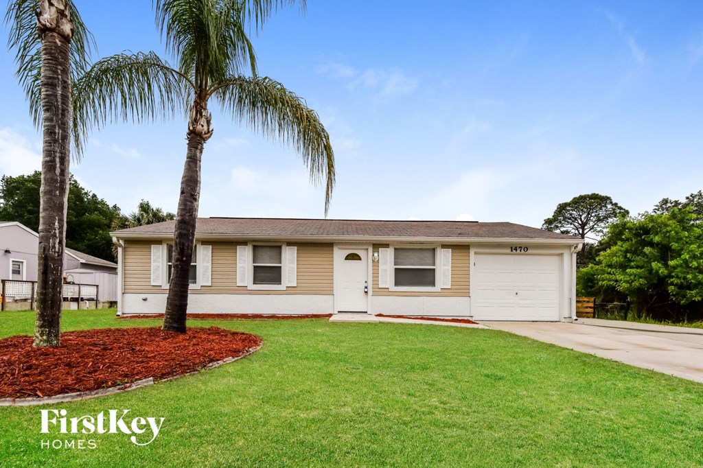 A house with a palm tree in front of it.