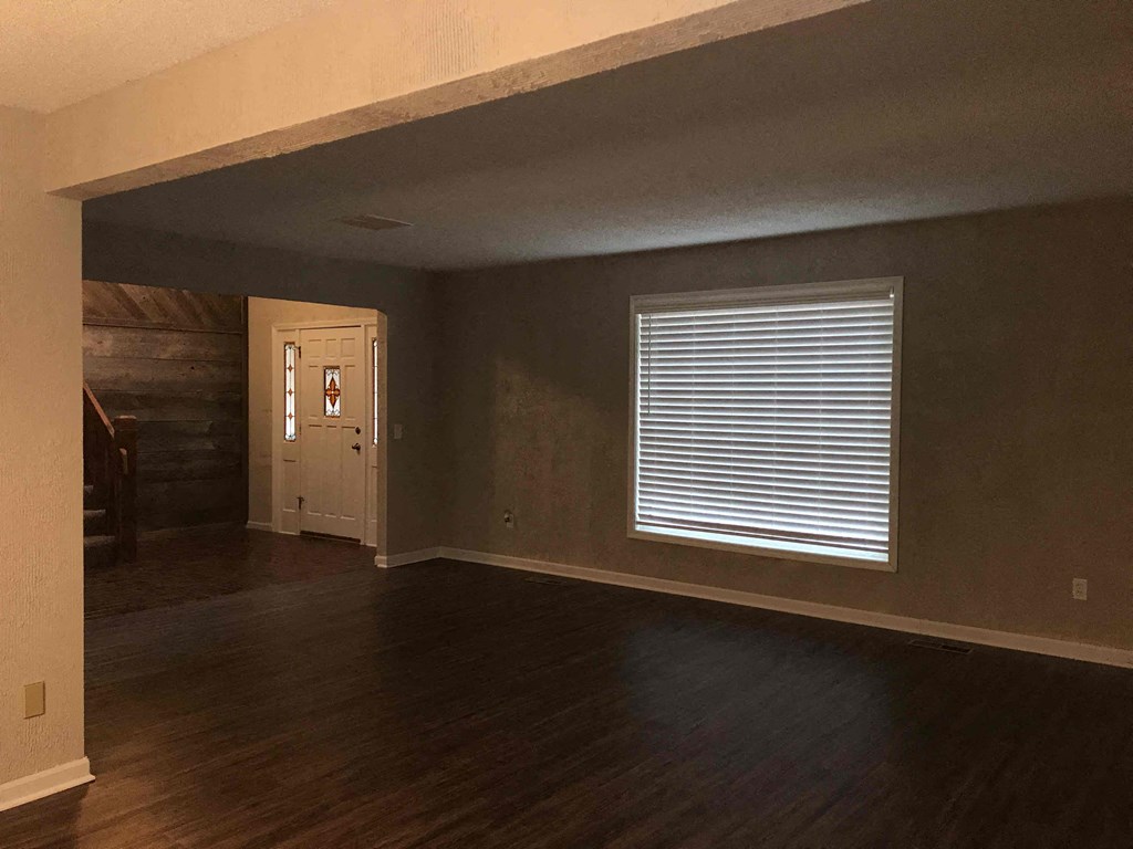 A room with a wooden floor and a white door.