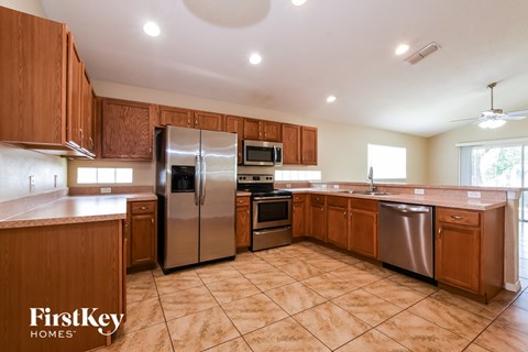 A kitchen with wooden cabinets and stainless steel appliances.