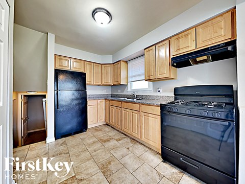 a kitchen with black appliances and wooden cabinets