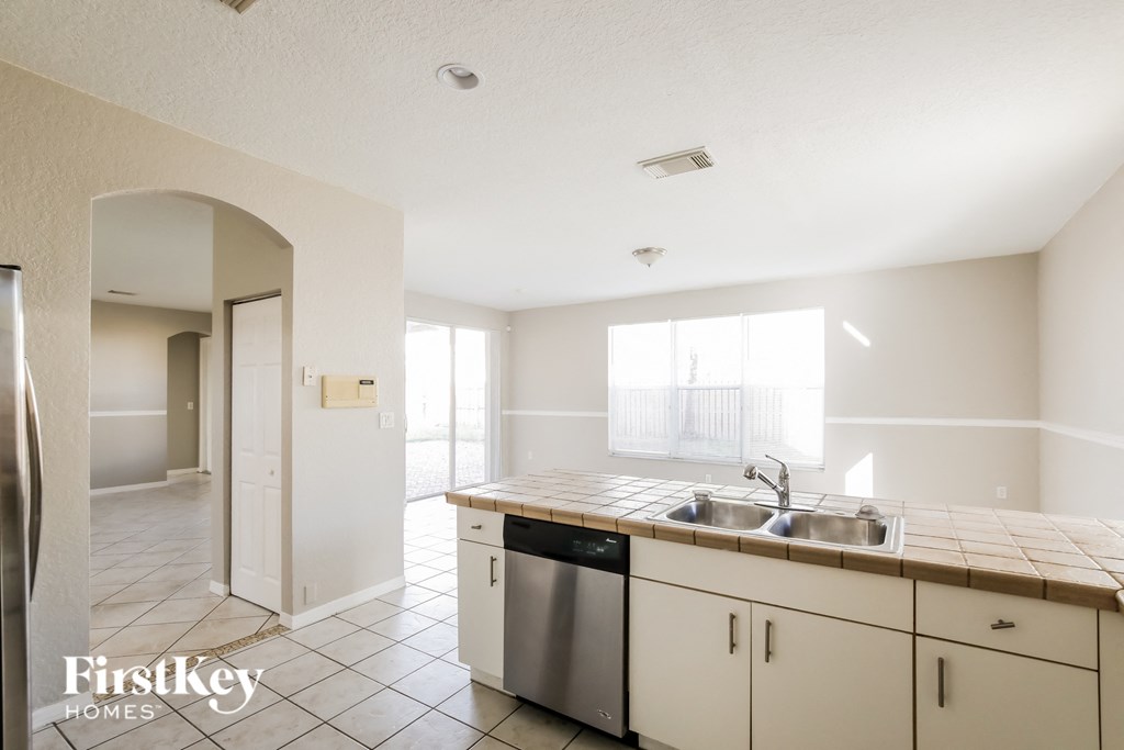 A kitchen with a sink and a dishwasher.