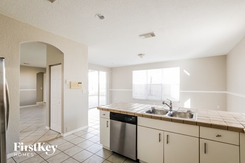 A kitchen with a sink and a dishwasher.