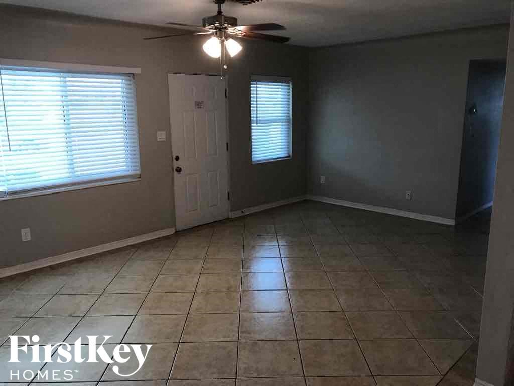 A room with a tiled floor and a ceiling fan.