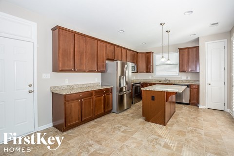 a kitchen with wooden cabinets and stainless steel appliances