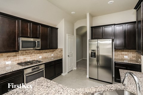 a kitchen with stainless steel appliances and granite counter tops