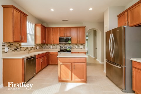a kitchen with wooden cabinets and stainless steel appliances