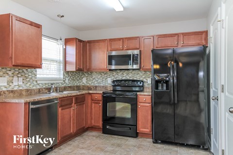 a kitchen with wooden cabinets and black appliances