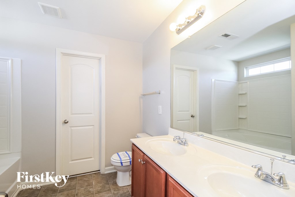 a bathroom with two sinks and a large mirror