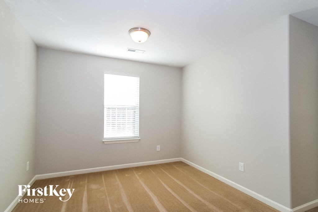 a empty room with a window and a wooden floor