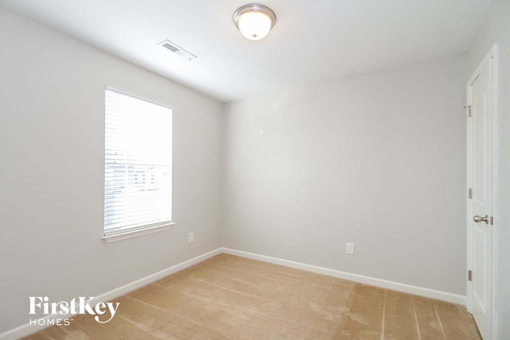 a empty room with a window and a door