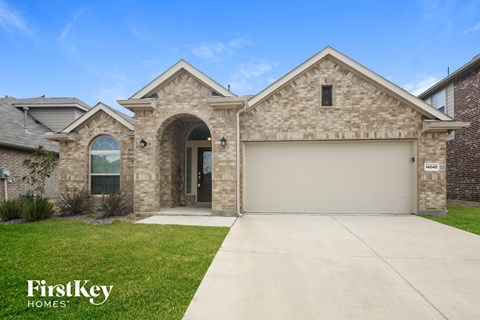 a brick house with a garage and a driveway