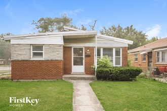 a small brick house with a white front door
