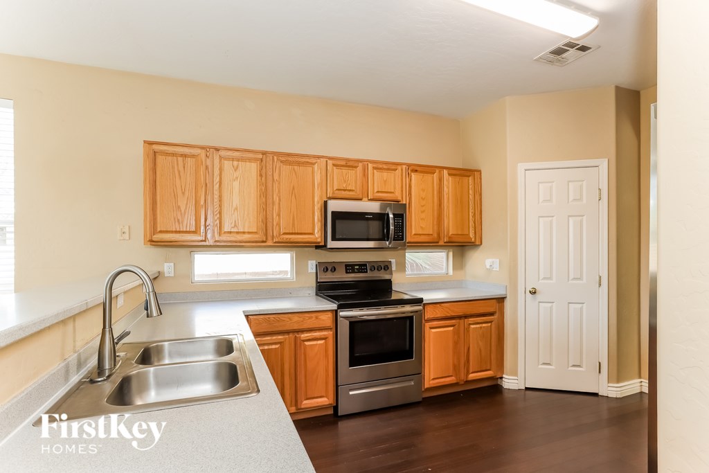A kitchen with wooden cabinets and stainless steel appliances.