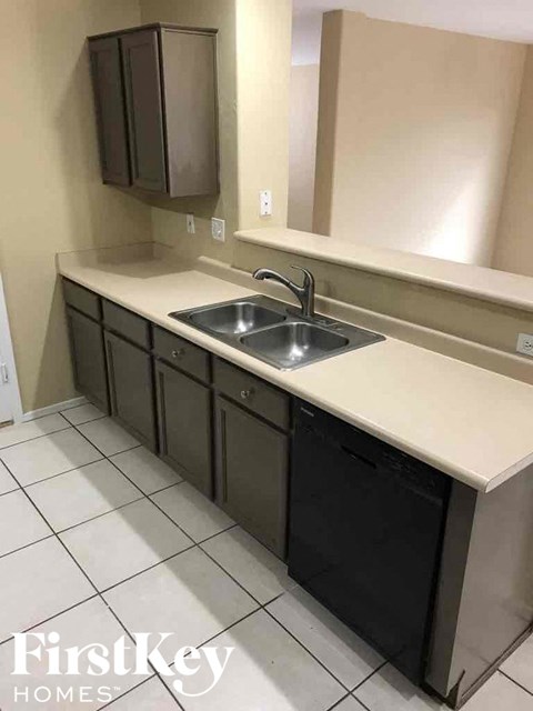A kitchen with a sink and cabinets.