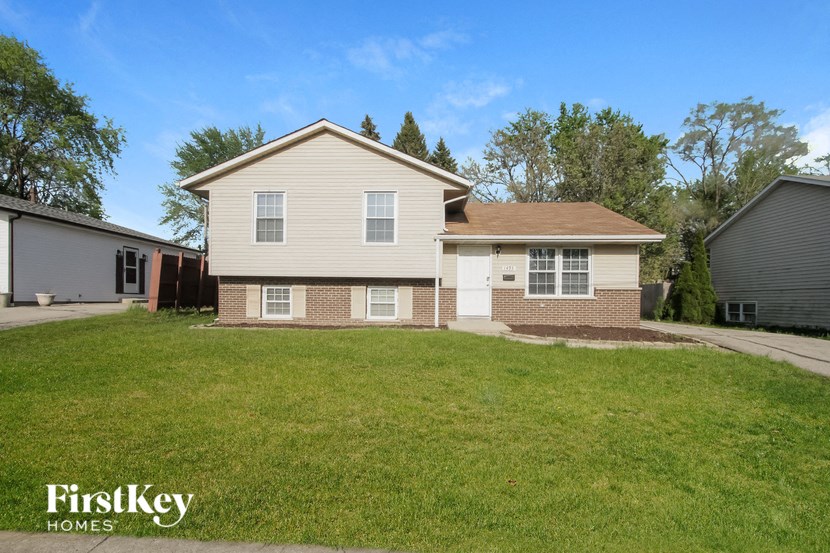 A house with a lawn in front of it is for sale.