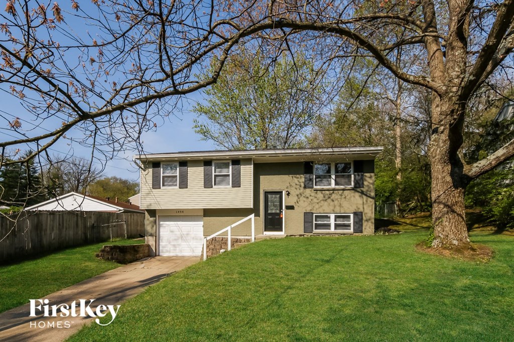A house with a tree in front of it.