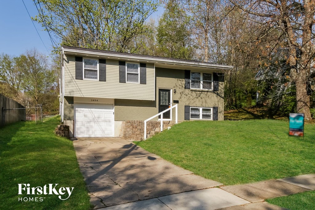 A house with a garage is for sale.