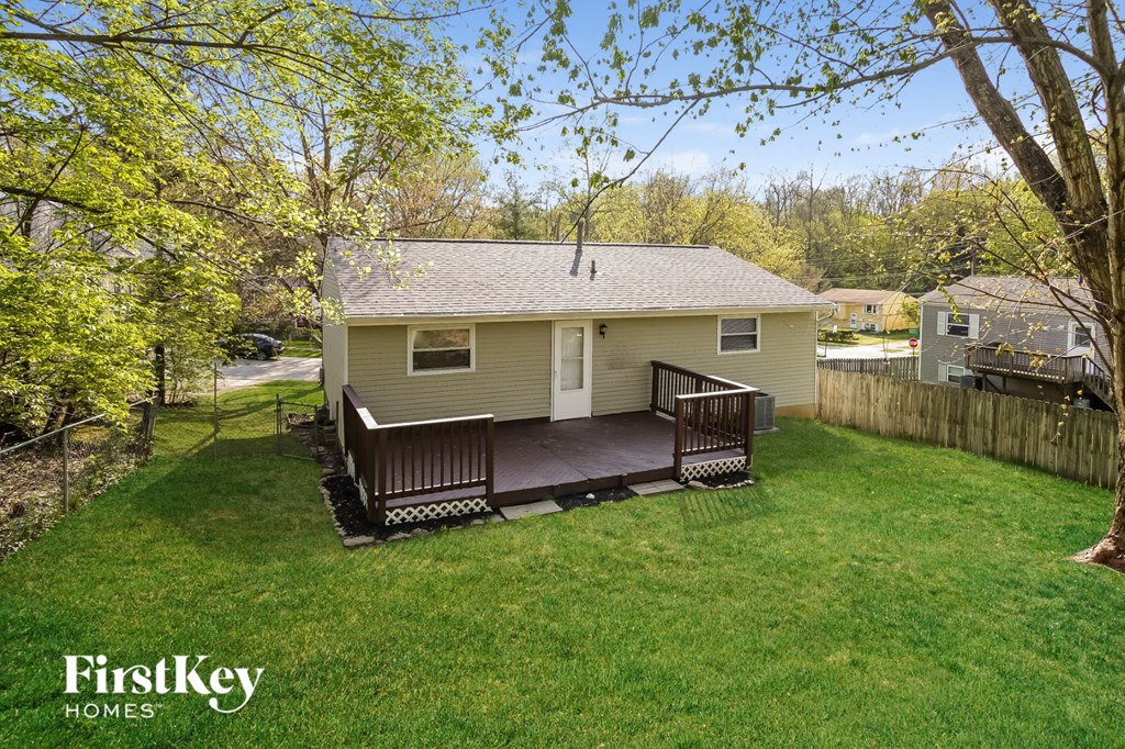 A house with a deck in the backyard.