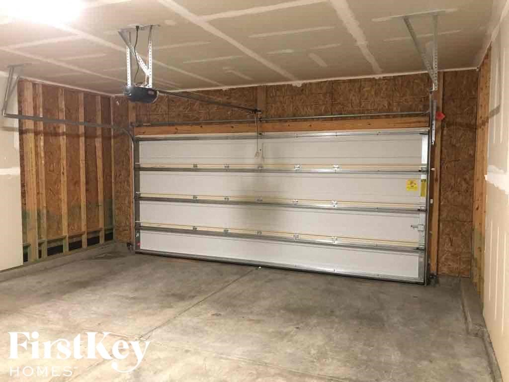 A garage with a white door is under construction.