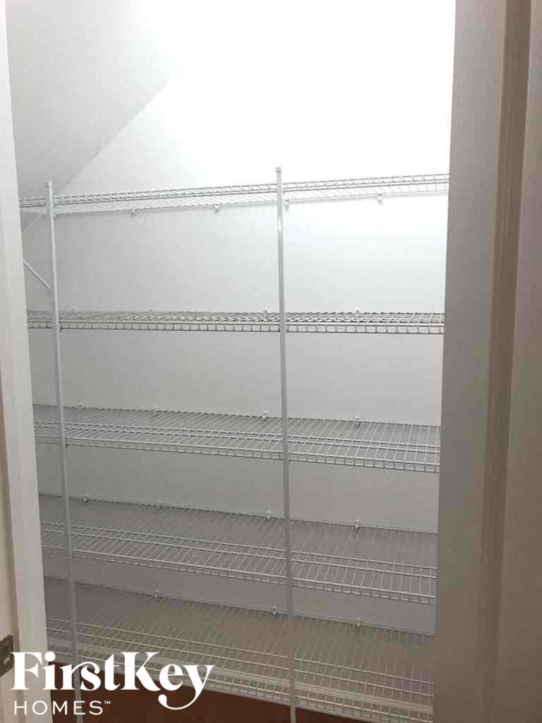 Empty white shelves in a room.