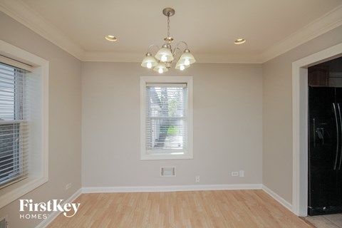 a dining room with a chandelier and a window