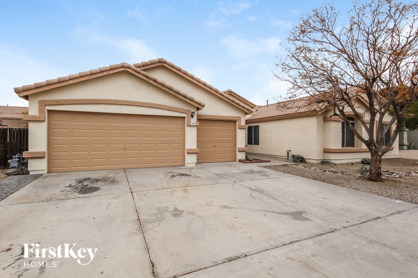 A house with a brown garage door is for sale by FirstKey Homes.