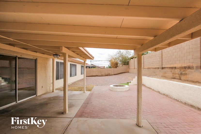 A covered walkway with a brick floor and a FirstKey Homes logo.
