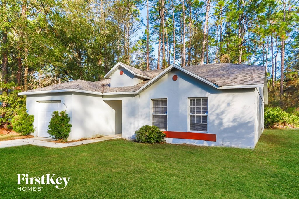 a white house with a red stripe on the side of it