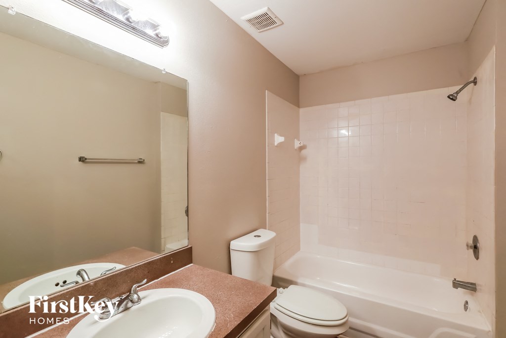 a bathroom with a sink toilet and a tub