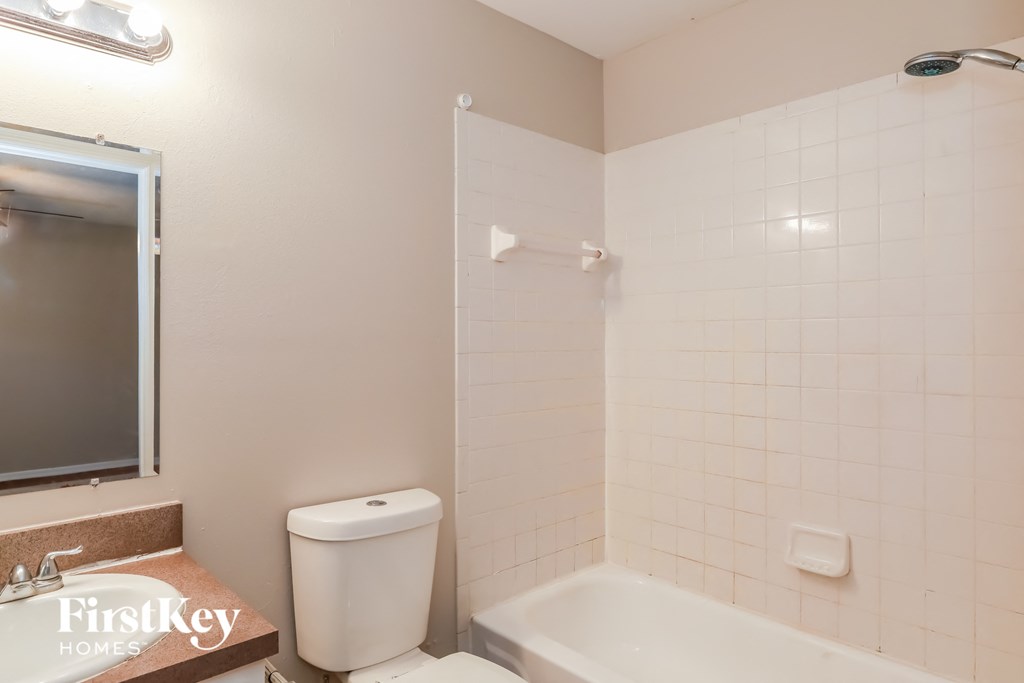 a bathroom with a toilet and a tub and a sink