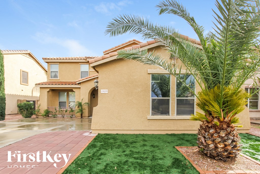 a palm tree in front of a house