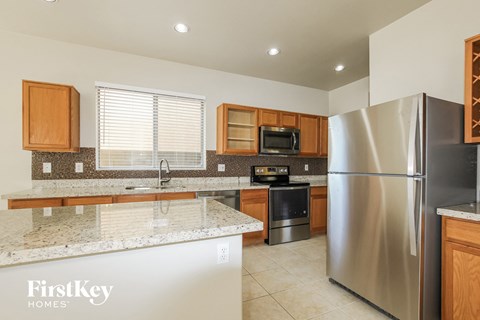 a kitchen with granite counter tops and stainless steel appliances