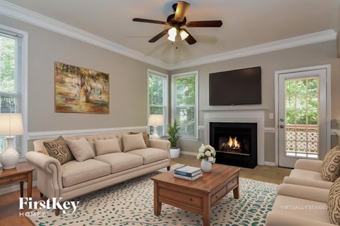 A living room with a fireplace and a painting on the wall.