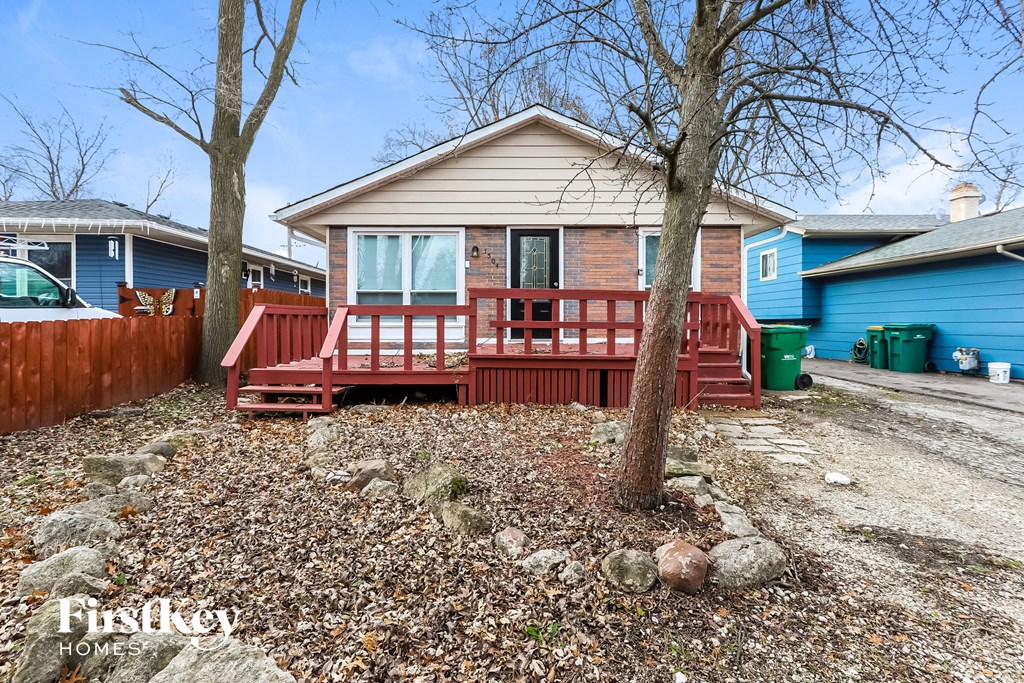 a small house with a red deck in front of it