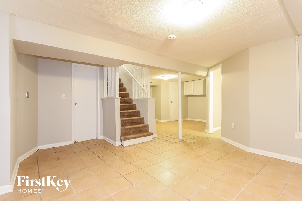 the living room and dining room with the stairs to the second floor