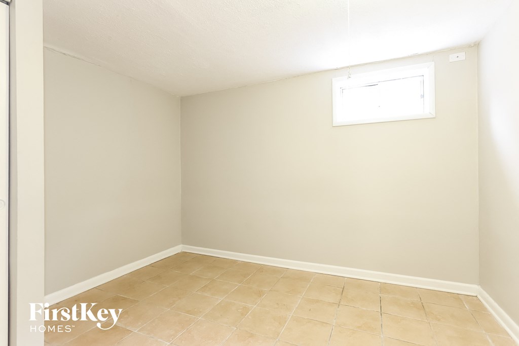 a empty room with a window and a tiled floor