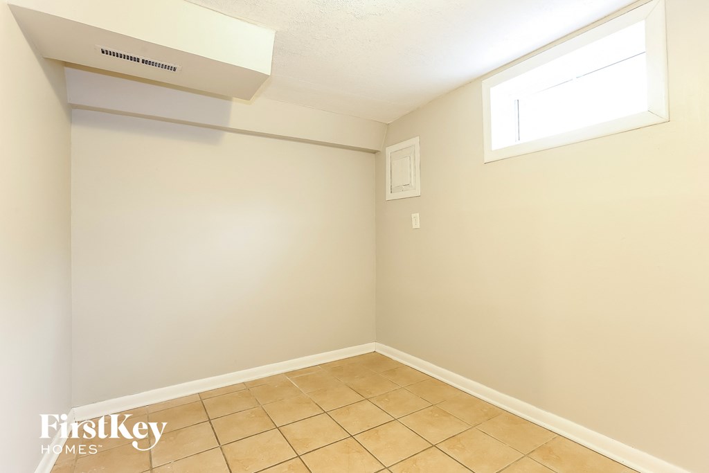 a empty room with a tiled floor and a window