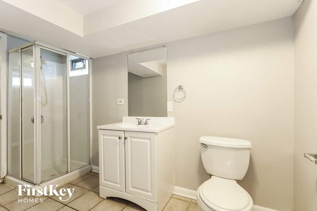 a bathroom with a toilet and a sink and a shower