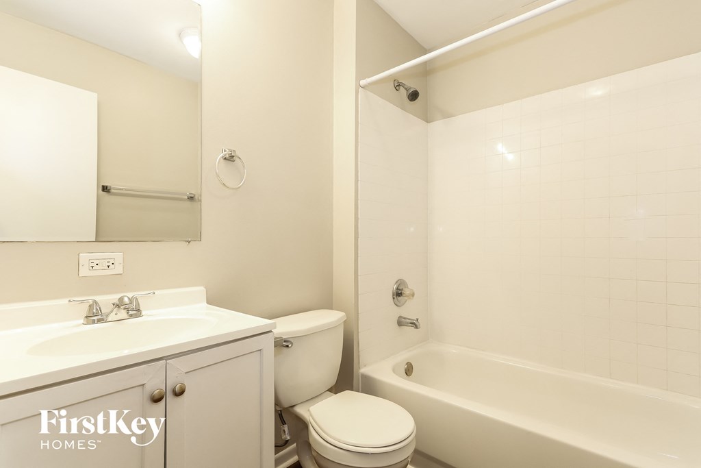 a white bathroom with a sink toilet and bath tub