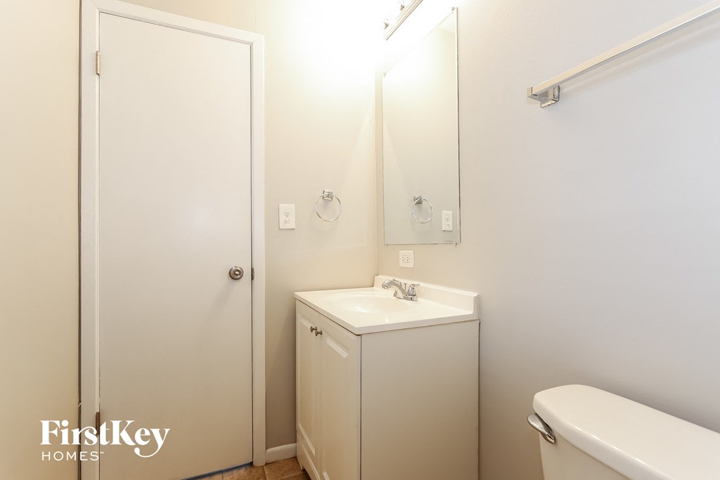 a small bathroom with a sink and a mirror and a toilet