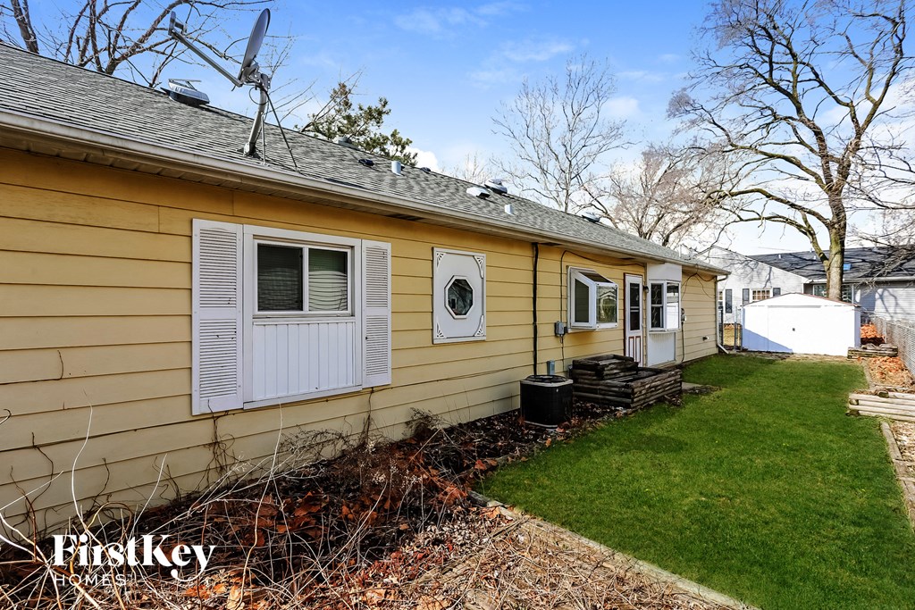 A yellow house with a satellite dish on the roof.